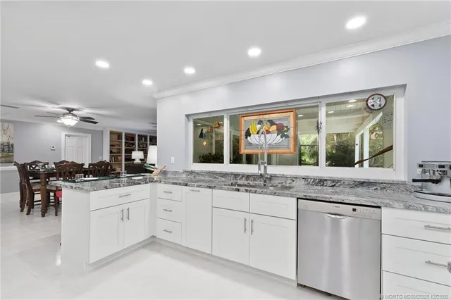 a bathroom with a granite countertop sink a mirror and shower