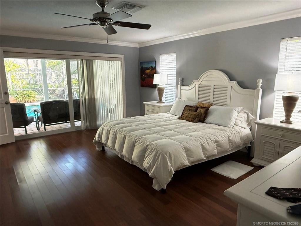 20 Banyan Road Stuart, FL 34996 - Photo 38 of 95 a bedroom with a bed and glass door
