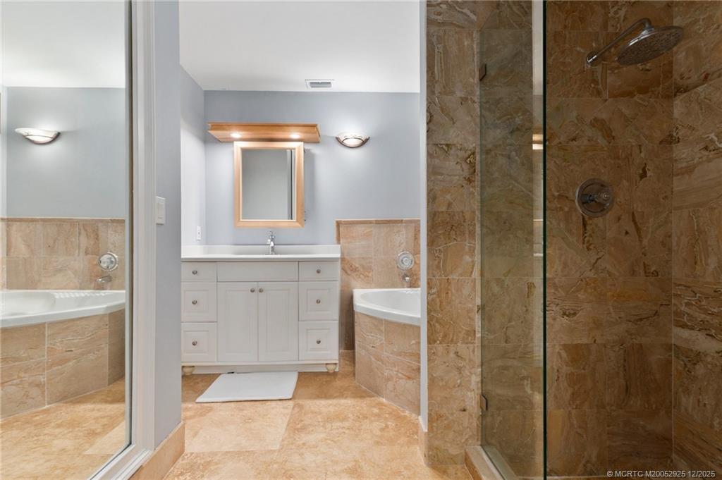 20 Banyan Road Stuart, FL 34996 - Photo 39 of 95 a bathroom with a granite countertop sink a mirror and shower