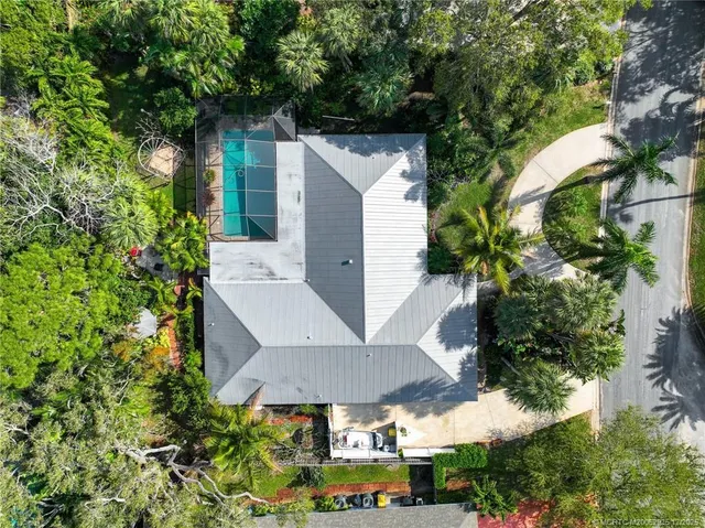 an aerial view of a house with a yard