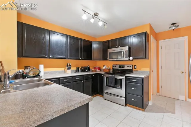 a kitchen with stainless steel appliances granite countertop a stove and a sink