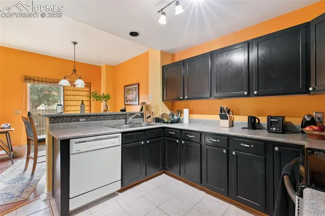a kitchen with stainless steel appliances granite countertop a sink counter space cabinets and a large window