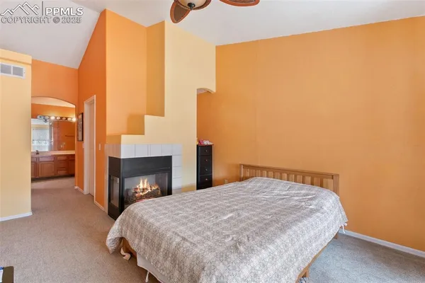 a bedroom with a bed and a fireplace