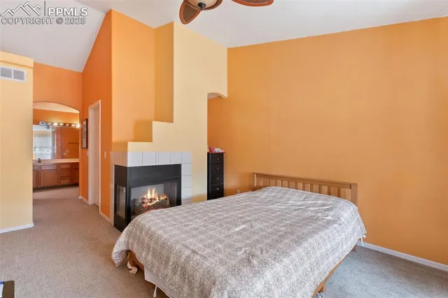 a bedroom with a bed and a fireplace