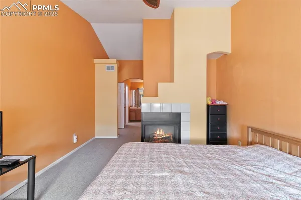 a bedroom with a bed and a fireplace
