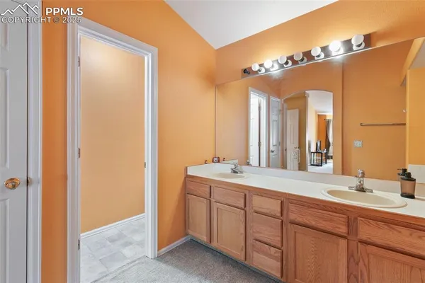 a bathroom with a double vanity sink and a mirror