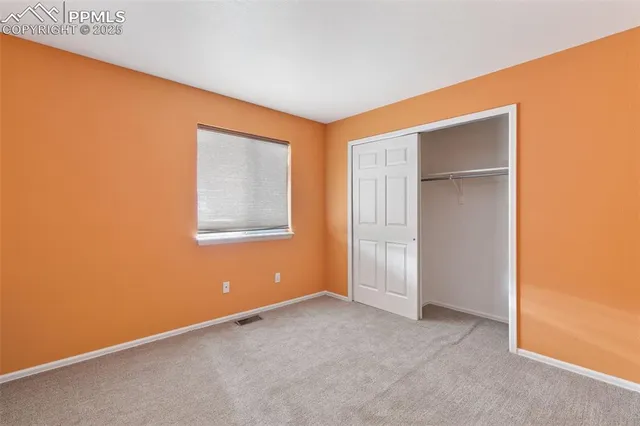 an empty room with closet area