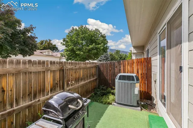 a backyard of a house with table and chairs