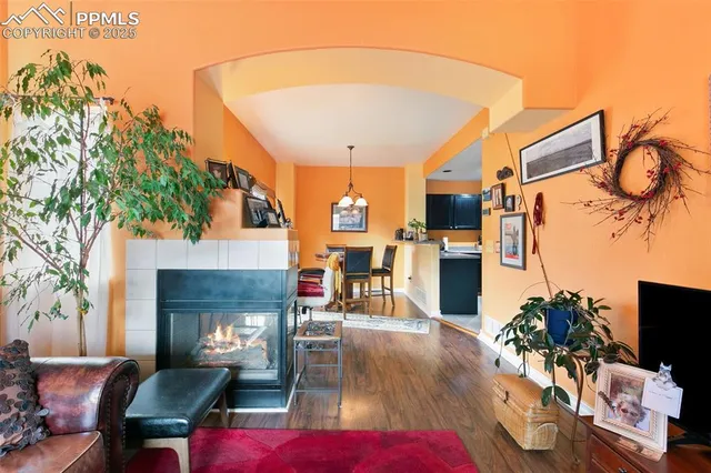 a living room with furniture a flat screen tv and a fireplace