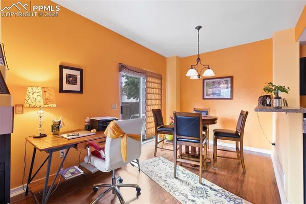 a dining room with furniture and wooden floor