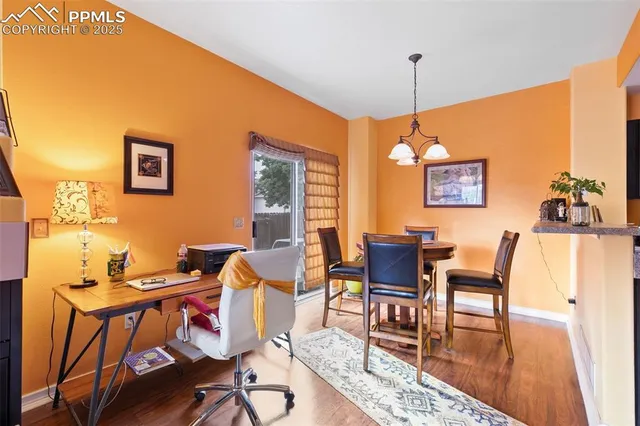 a dining room with furniture and wooden floor