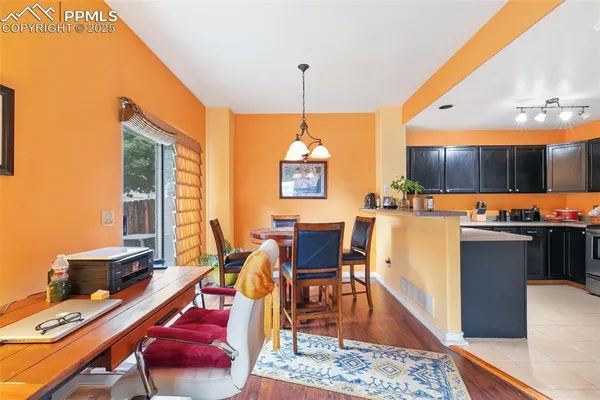 a living room with dining room and wooden floor