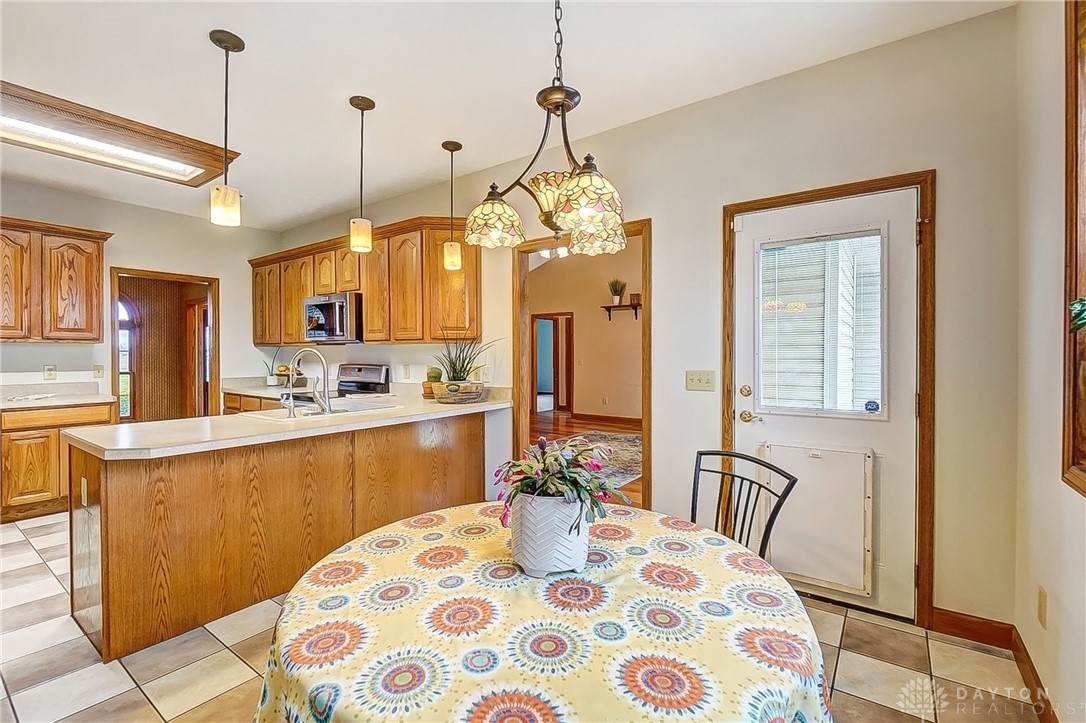 1540 Jasper Road Xenia, OH 45385 - Photo 22 of 91 This spacious kitchen with warm wood cabinetry offers a delightful eat-in area for casual dining.