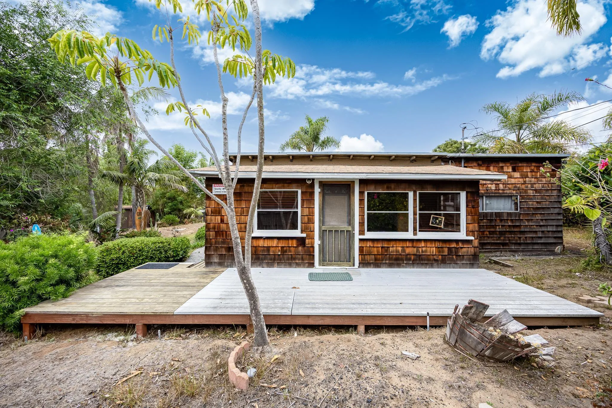890 Capri Road Encinitas, CA 92024 - Photo 16 of 43 a view of a house with backyard sitting area and porch