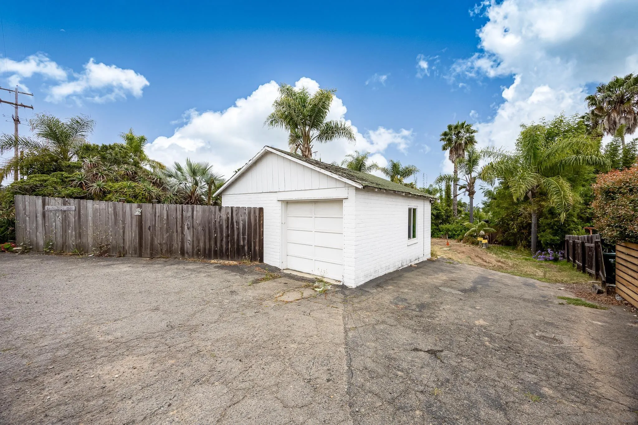 890 Capri Road Encinitas, CA 92024 - Photo 20 of 43 a view of backyard with small cabin and wooden fence