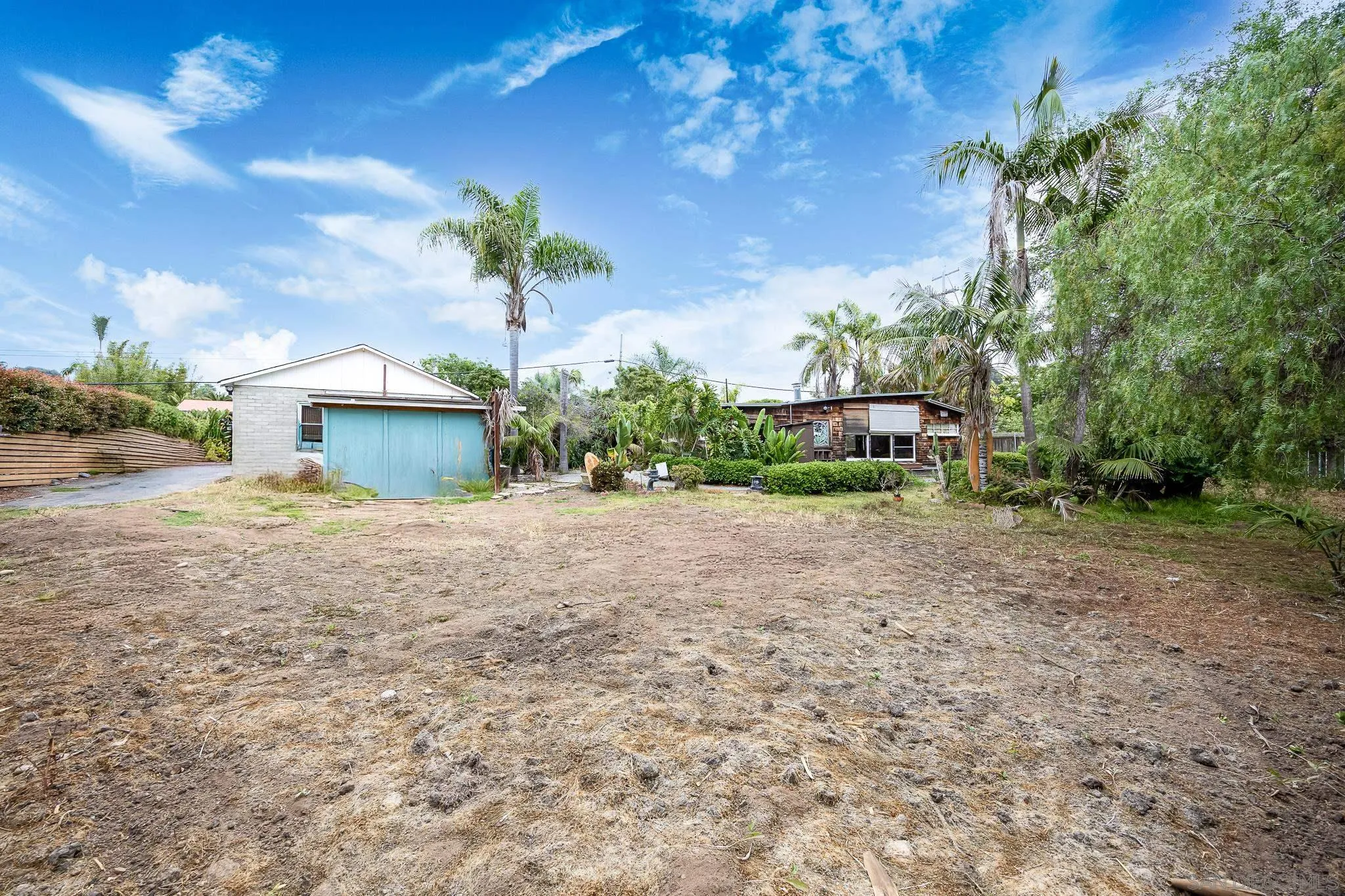 890 Capri Road Encinitas, CA 92024 - Photo 24 of 43 a front view of a house with a yard and a garage