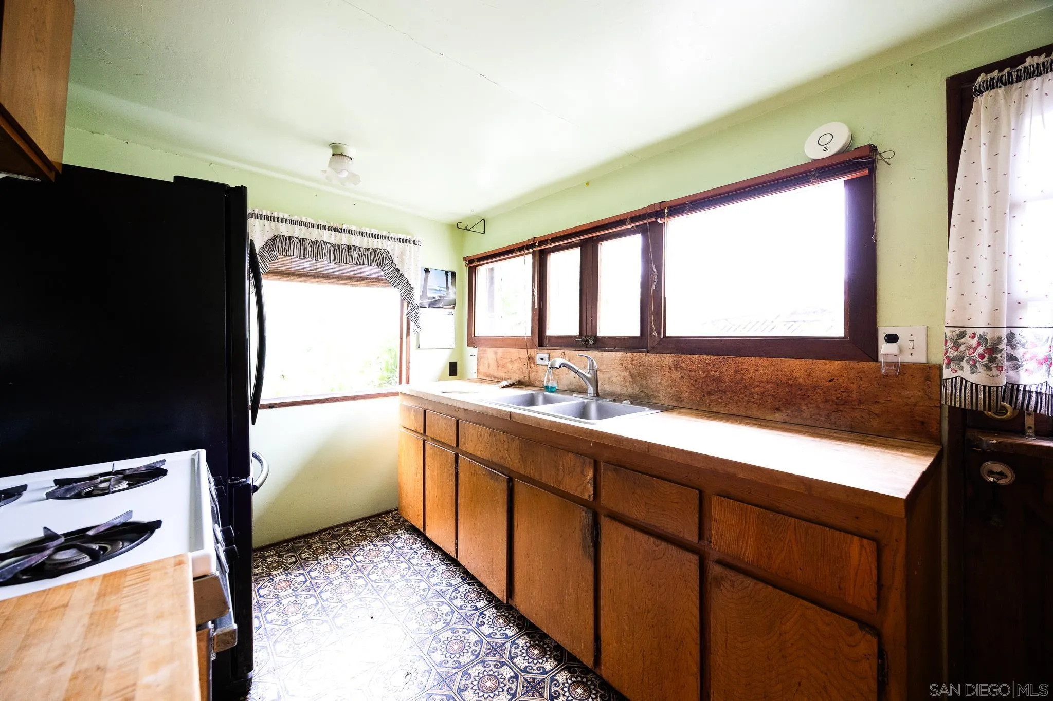 890 Capri Road Encinitas, CA 92024 - Photo 38 of 43 a kitchen with a refrigerator and a sink