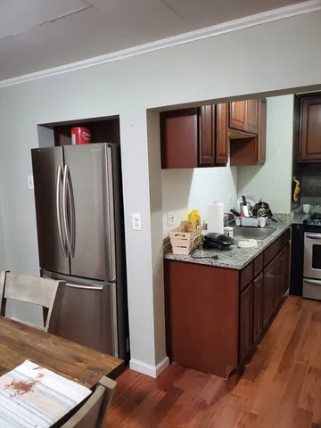 a kitchen with stainless steel appliances granite countertop a refrigerator stove and sink