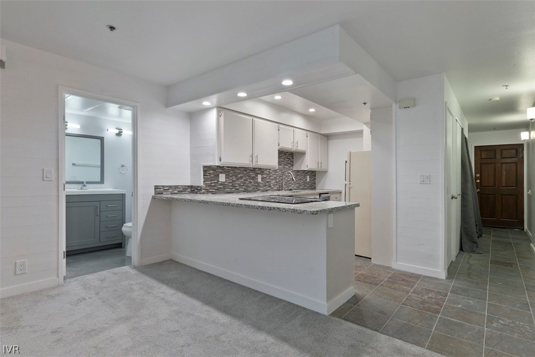 333 Ski Way, Unit 281 Incline Village, NV 89451 - Photo 7 of 35 a large white kitchen with a refrigerator a sink and a stove