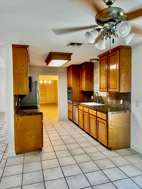 5005 Cascade Drive Corpus Christi, TX 78413 - Photo 5 of 14 a kitchen with stainless steel appliances granite countertop a sink and a stove
