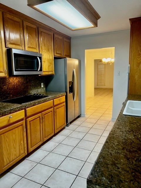 5005 Cascade Drive Corpus Christi, TX 78413 - Photo 6 of 14 a kitchen with stainless steel appliances granite countertop a refrigerator a stove top oven and a sink