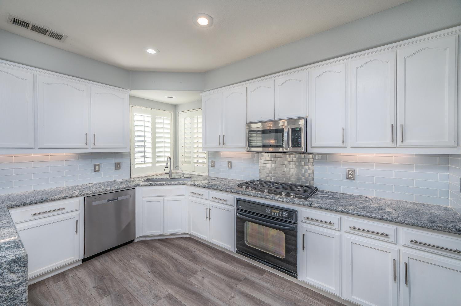2800 Olympus Court Modesto, CA 95356 - Photo 14 of 56 a kitchen with stainless steel appliances granite countertop a sink and cabinets