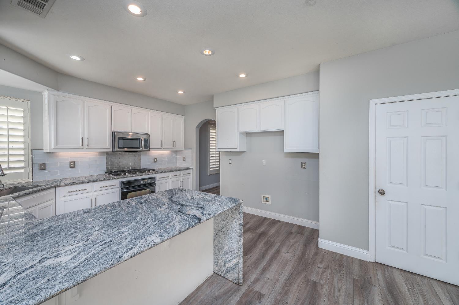 2800 Olympus Court Modesto, CA 95356 - Photo 17 of 56 a kitchen with stainless steel appliances granite countertop a refrigerator and a stove top oven