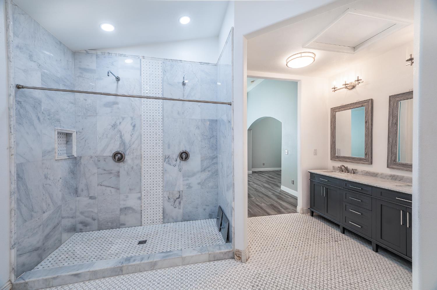 2800 Olympus Court Modesto, CA 95356 - Photo 42 of 56 a bathroom with a tub sink shower and mirror