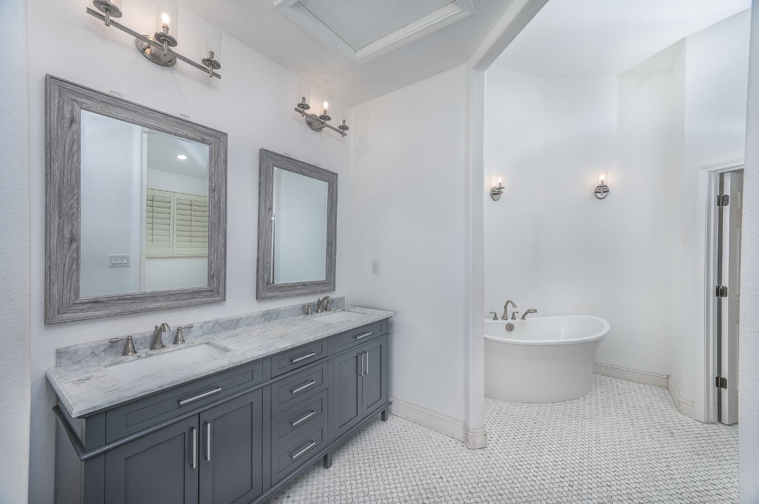 2800 Olympus Court Modesto, CA 95356 - Photo 44 of 56 a bathroom with a sink double vanity granite tub and a mirror