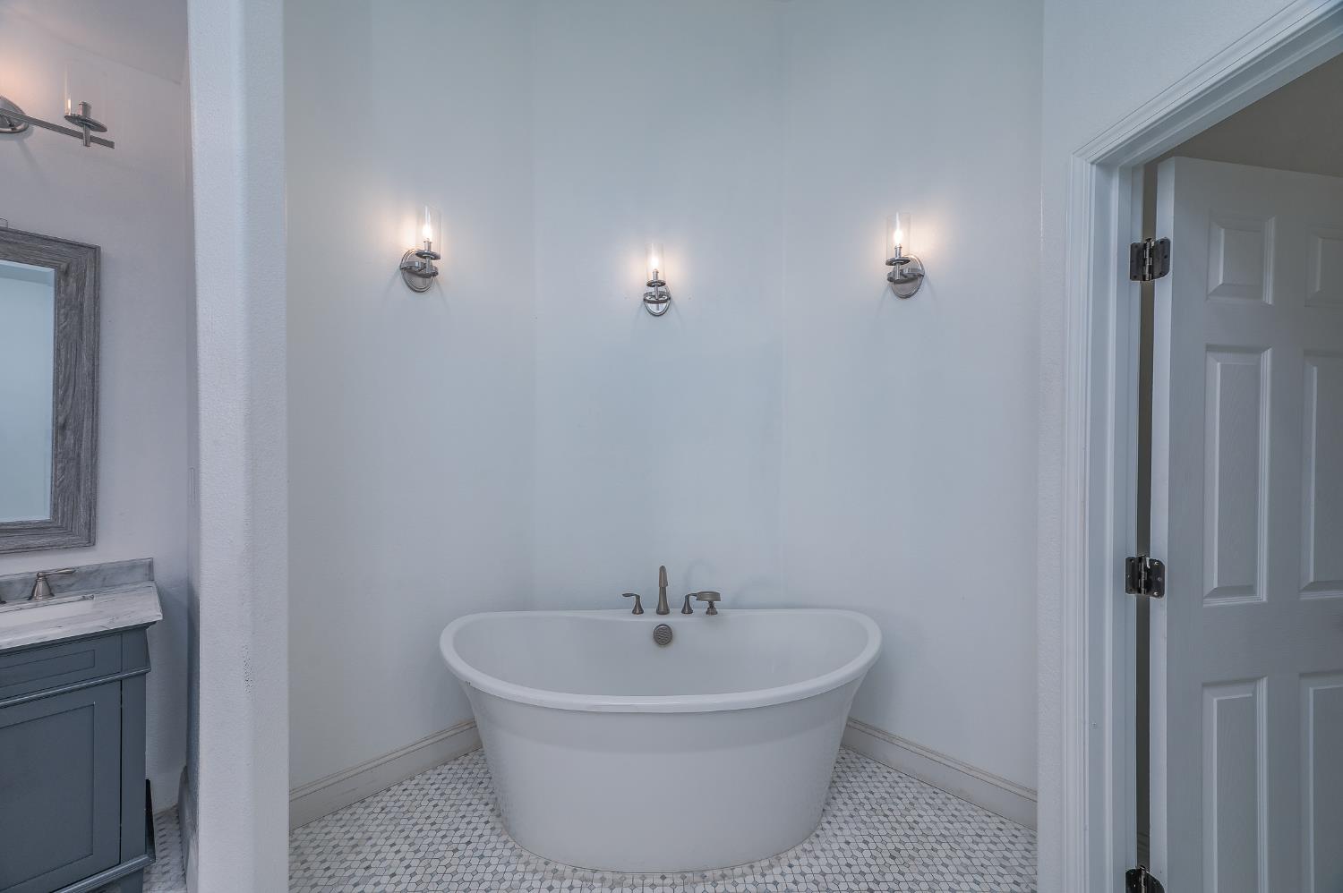 2800 Olympus Court Modesto, CA 95356 - Photo 45 of 56 a white bath tub sitting in a bathroom