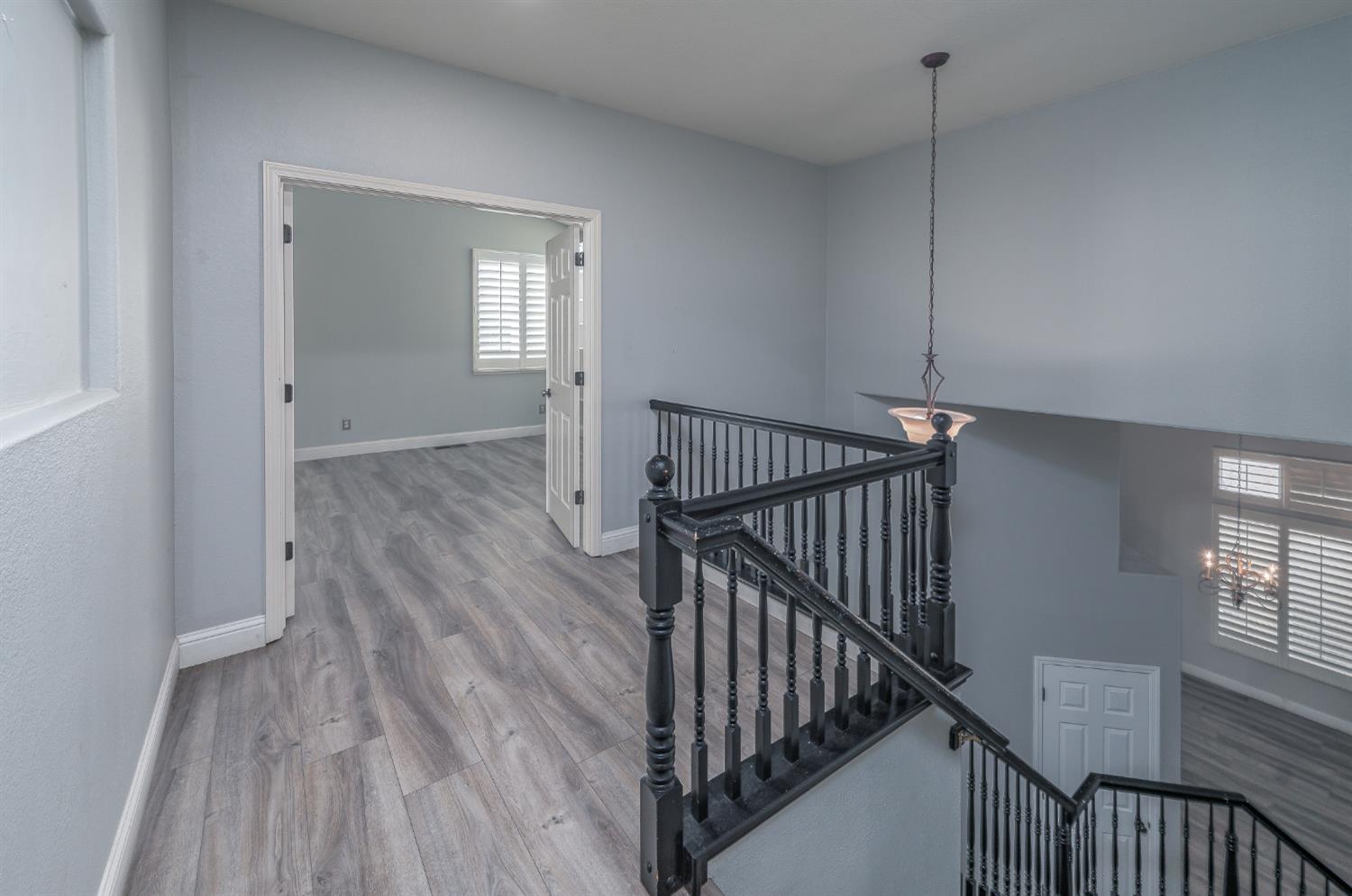 2800 Olympus Court Modesto, CA 95356 - Photo 47 of 56 a view of a hallway with wooden floor and stairs