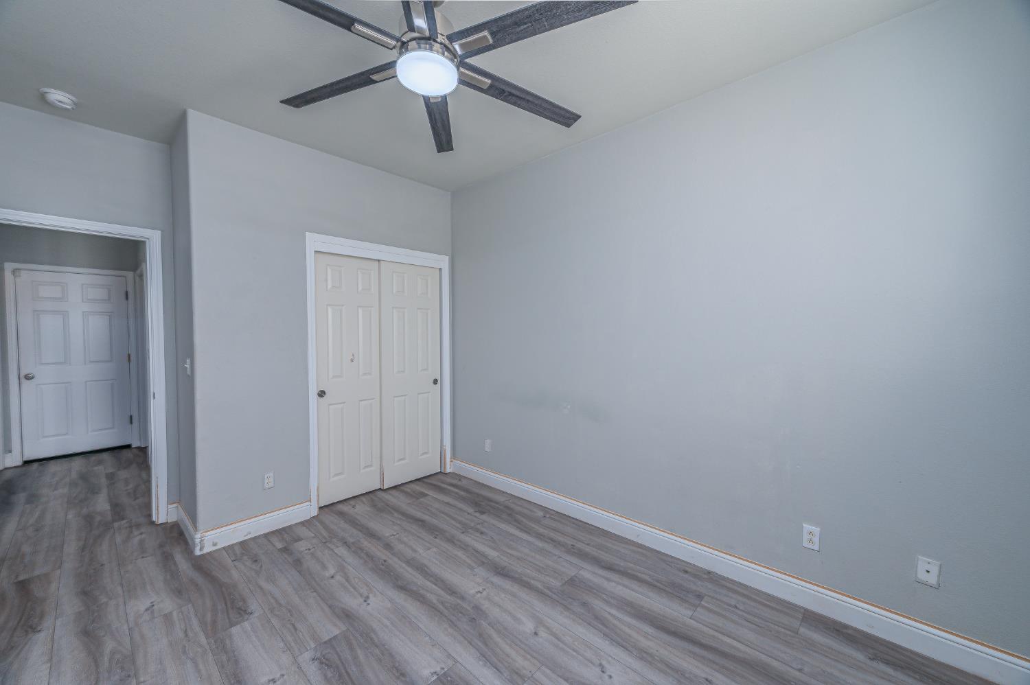 2800 Olympus Court Modesto, CA 95356 - Photo 50 of 56 a view of an empty room with wooden floor