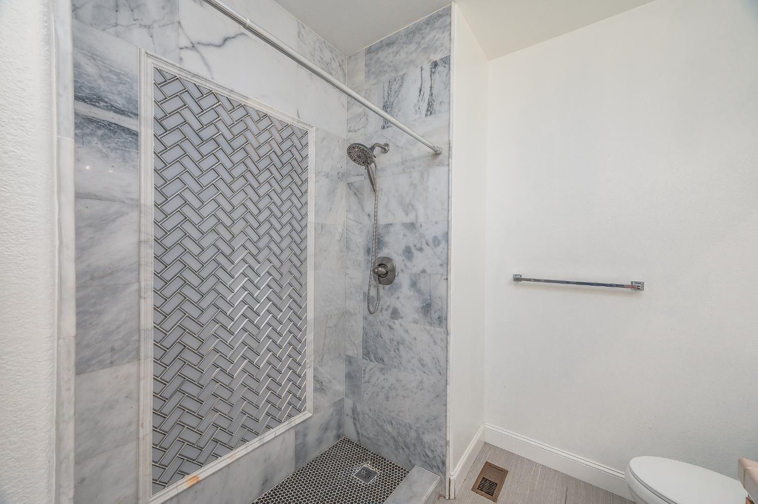 2800 Olympus Court Modesto, CA 95356 - Photo 51 of 56 a bathroom with a shower and toilet