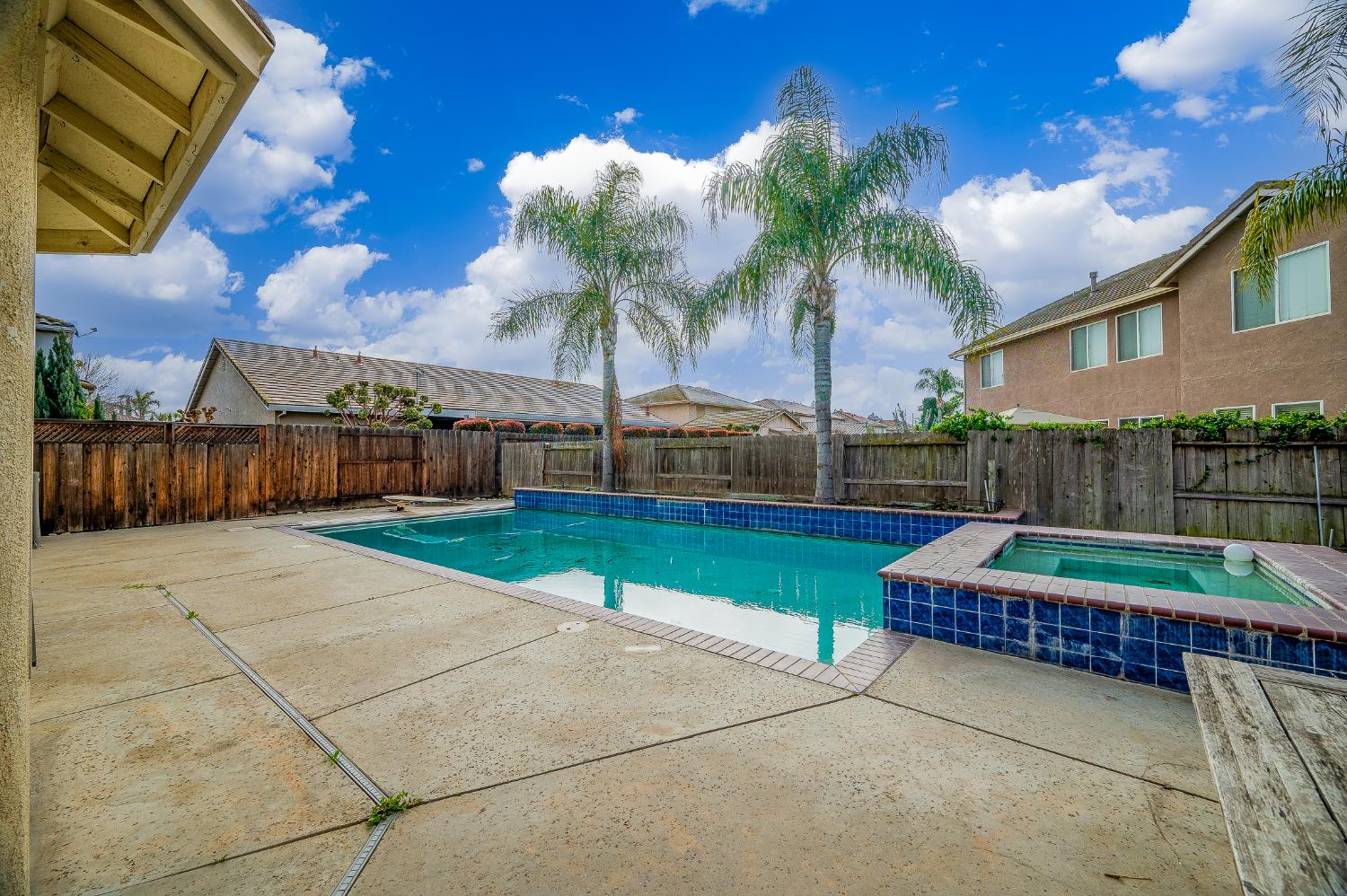 2800 Olympus Court Modesto, CA 95356 - Photo 8 of 56 a view of backyard with swimming pool and outdoor seating