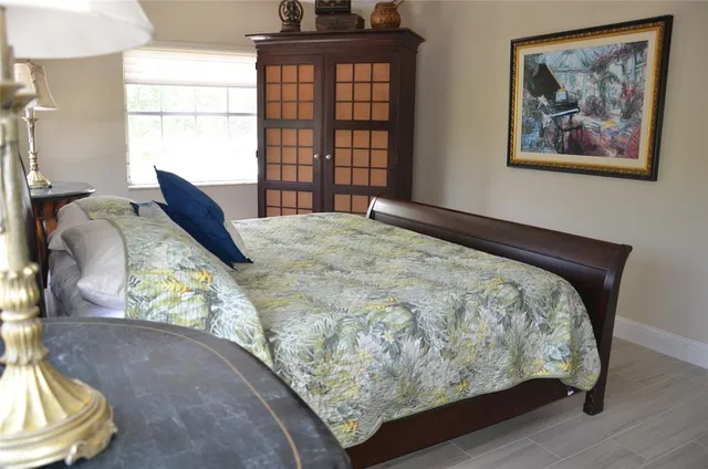 a bed sitting in a bedroom next to a window