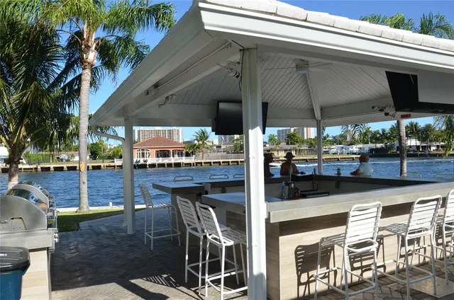 a view of a patio with a table and chairs under an umbrella