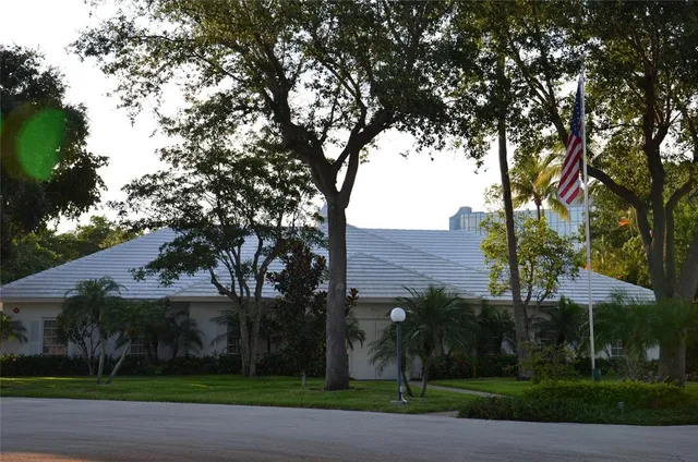 a living room with furniture kitchen view and a large window