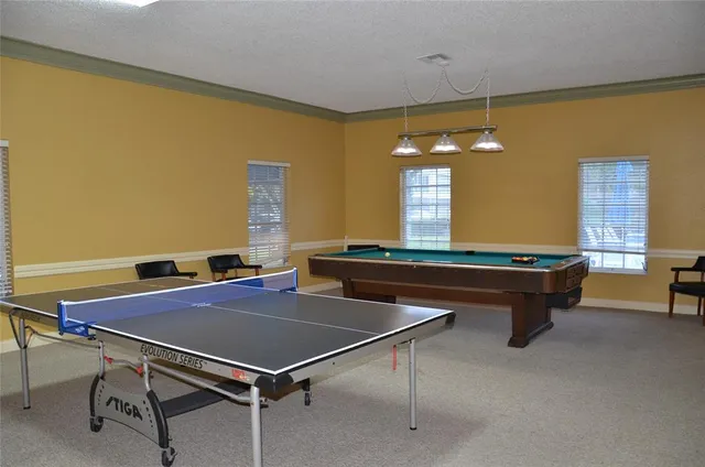 a view of a house with a yard and sitting area