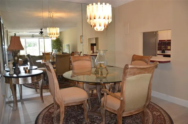 a view of a dining room with furniture and chandelier