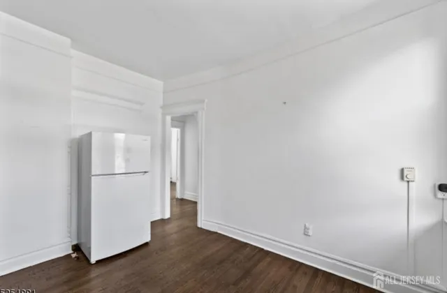 a view of a closet with wooden floor