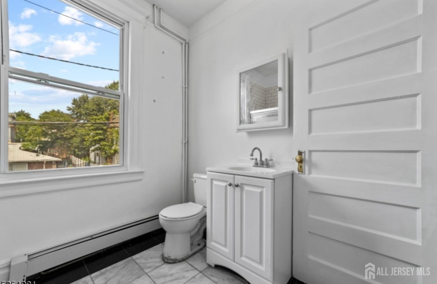 410 Chadwick Avenue, Unit 2 Newark, NJ 07112 - Photo 8 of 11 a view of bathroom with a toilet sink and a bathtub