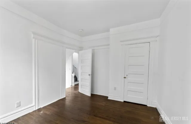 an empty room with wooden floor