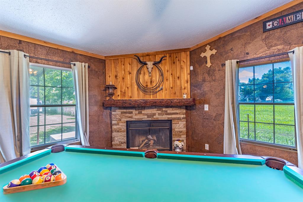 75 Southern Road Mineral Wells, TX 76067 - Photo 20 of 31 a living room with fireplace furniture and a fireplace