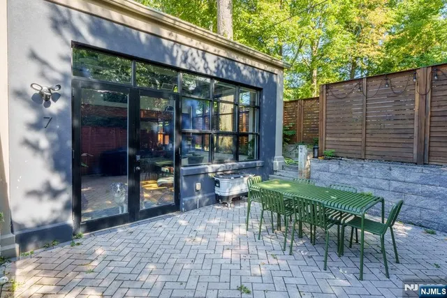 a view of a patio with table and chairs and potted plants