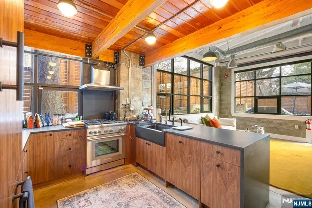 a kitchen with a sink stove and cabinets