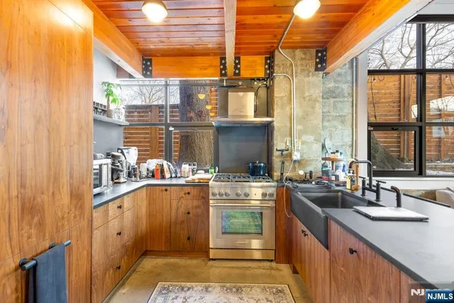 a kitchen with stainless steel appliances a sink and cabinets