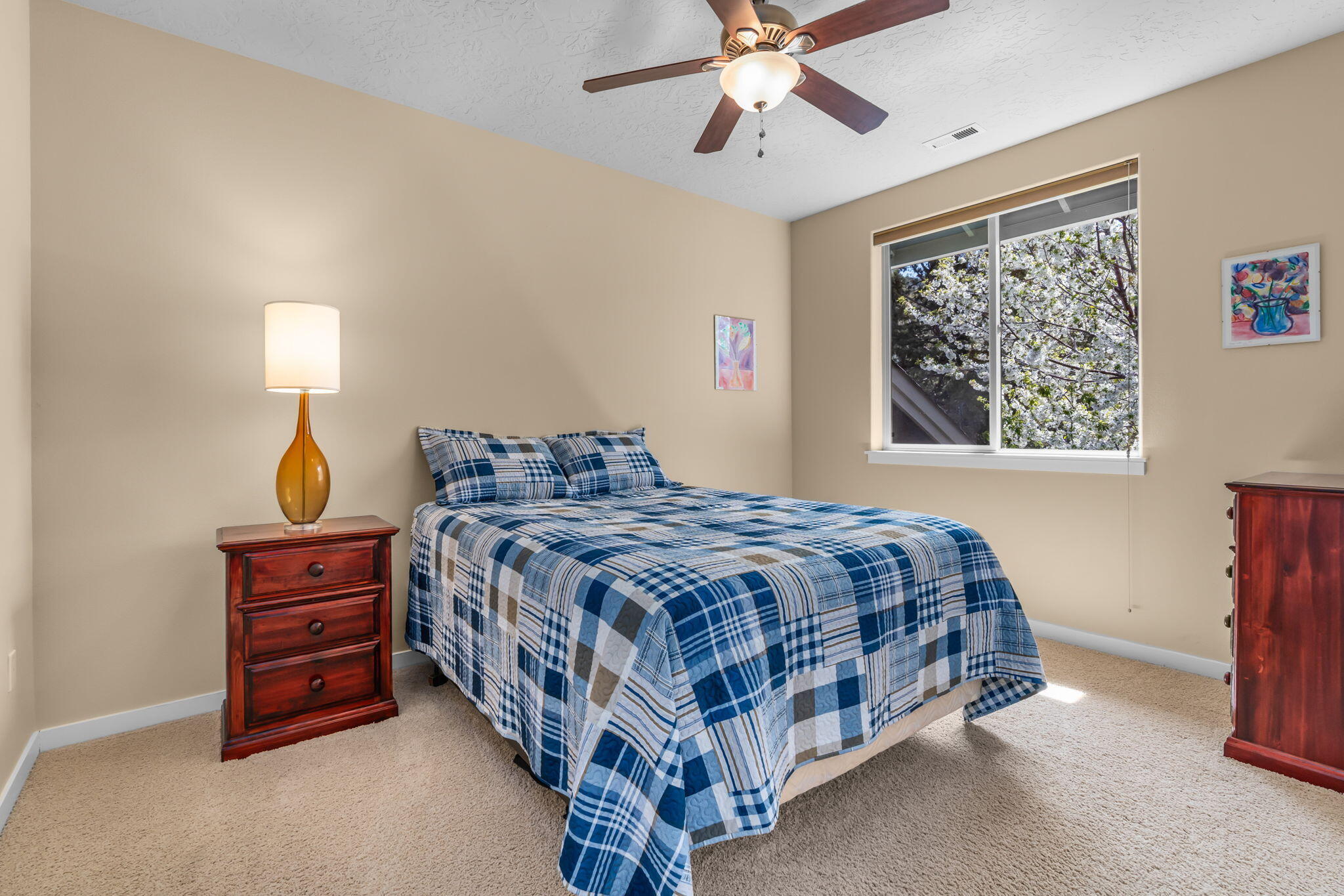 10870 Village Loop Redmond, OR 97756 - Photo 24 of 35 a bedroom with a bed dresser and a window