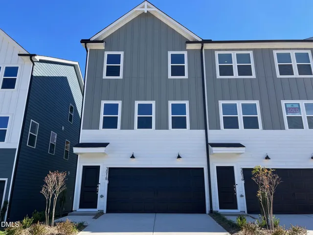 a front view of a building with a yard