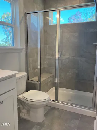 a bathroom with a toilet and a shower