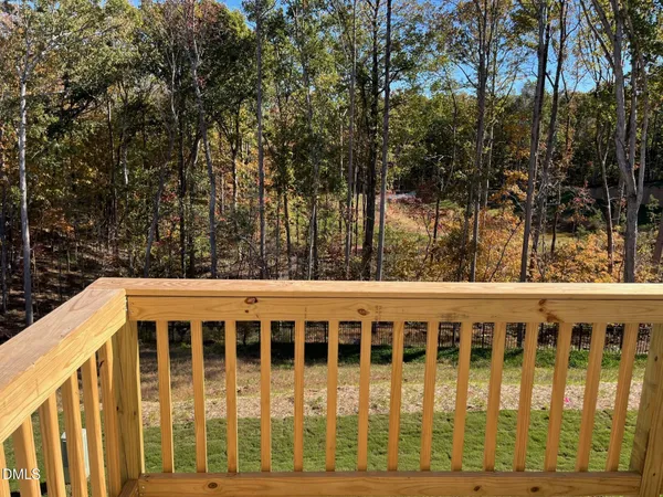 a view of a blue house with a backyard
